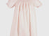 Light pink smocked pearl bishop dress