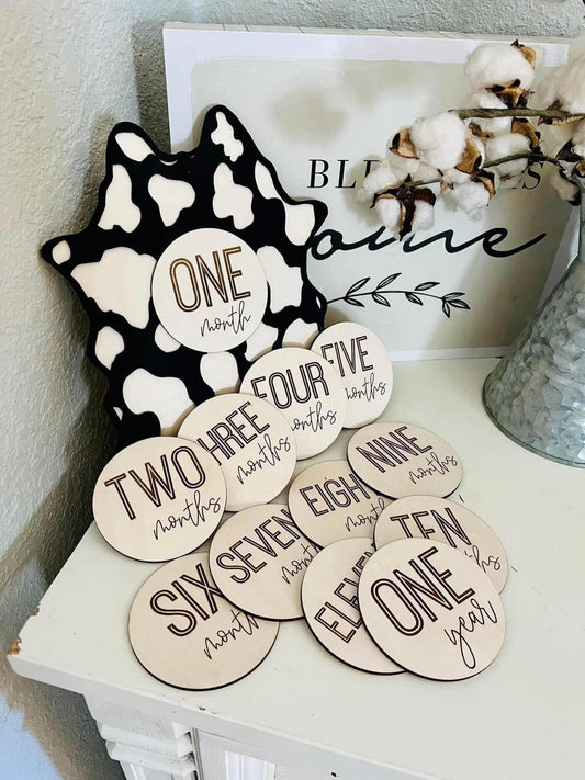 Cow print sign with milestone disc